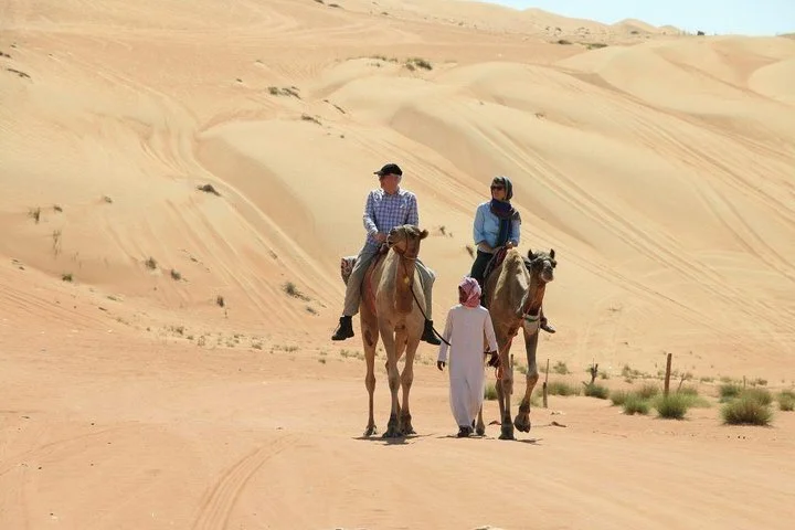 Morning Camel Trekking with Dune Bashing and Sand Boarding